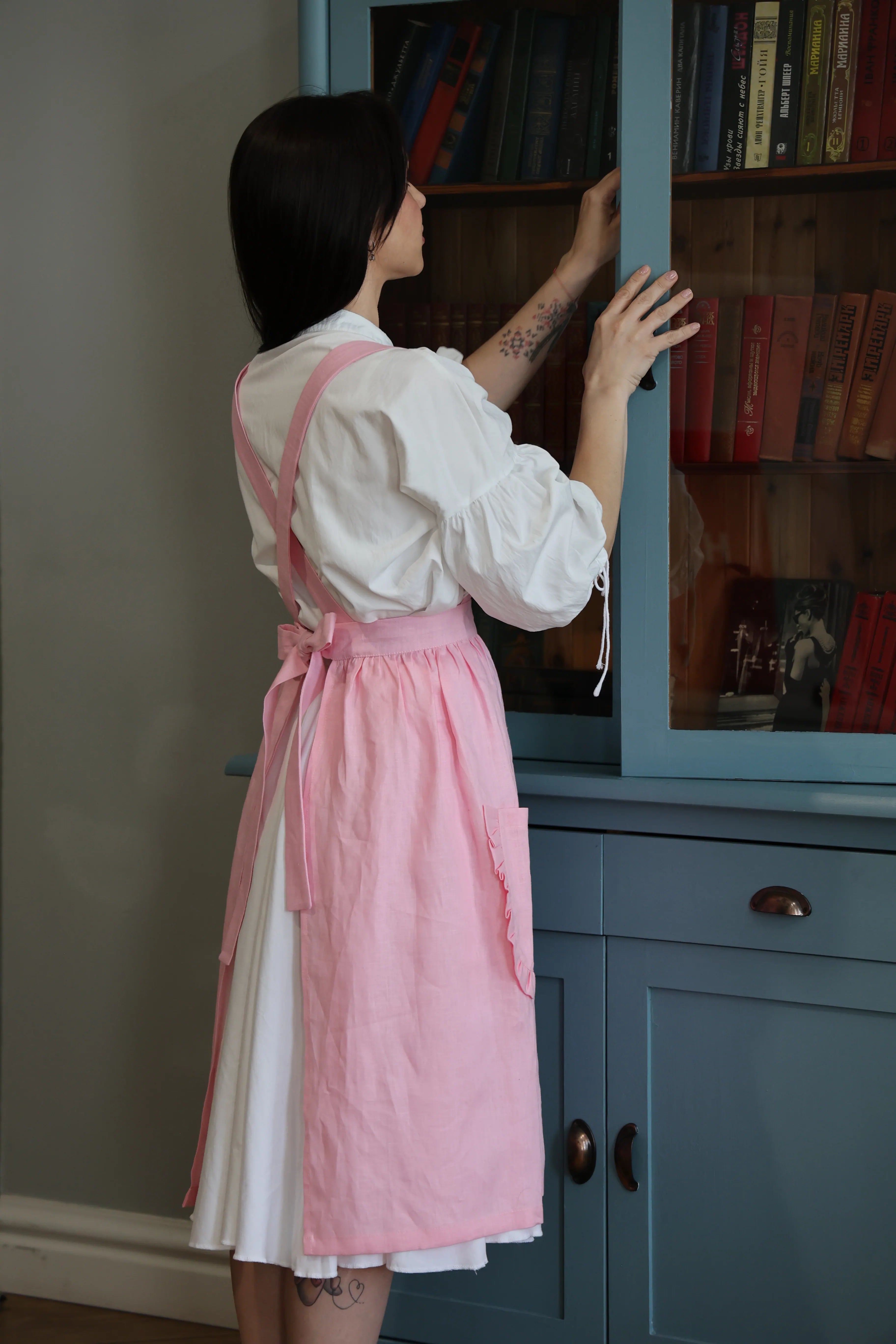 Side view of the soft pink cotton apron with ruffles