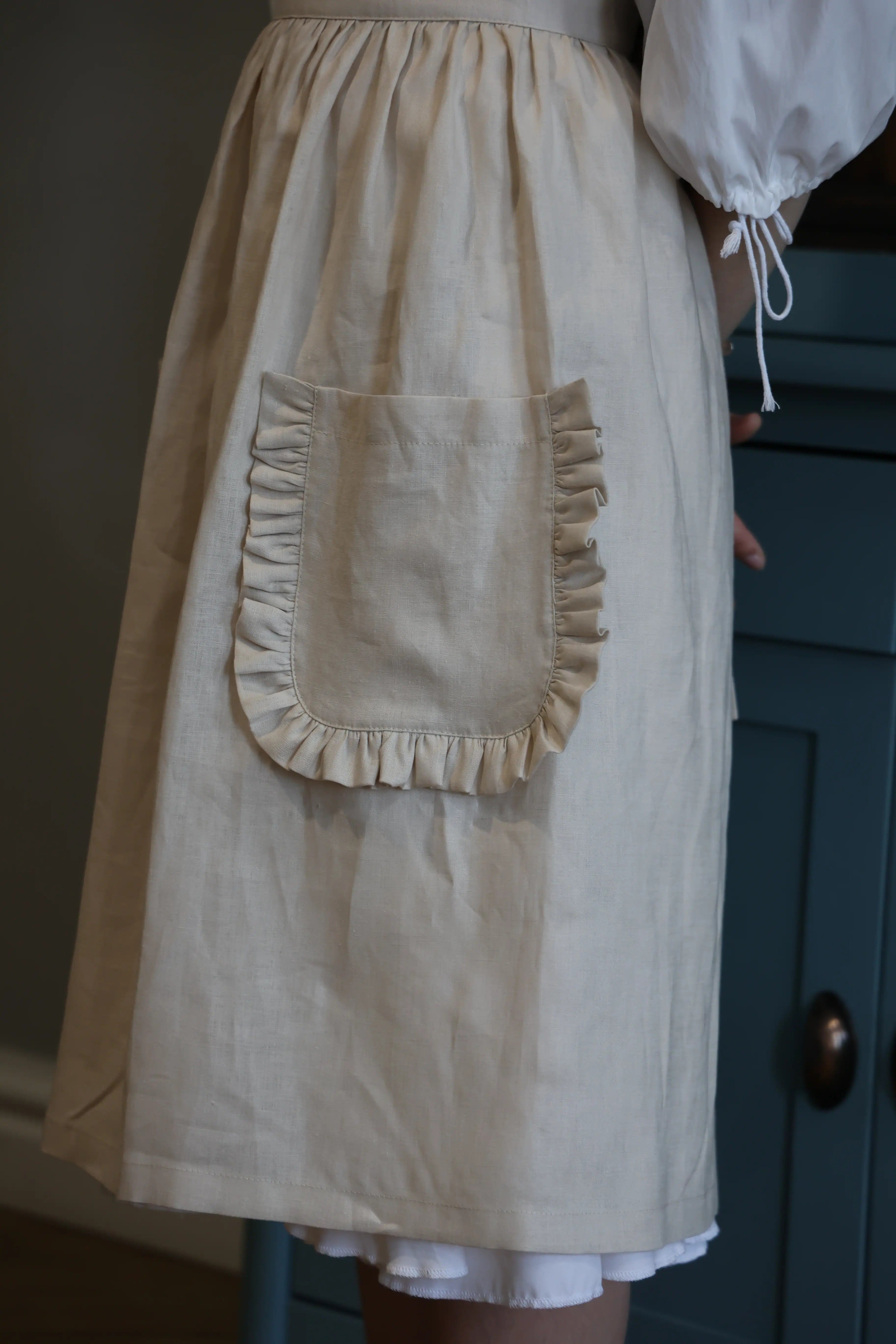 Close-up of the ruffled patch pocket on the sand apron