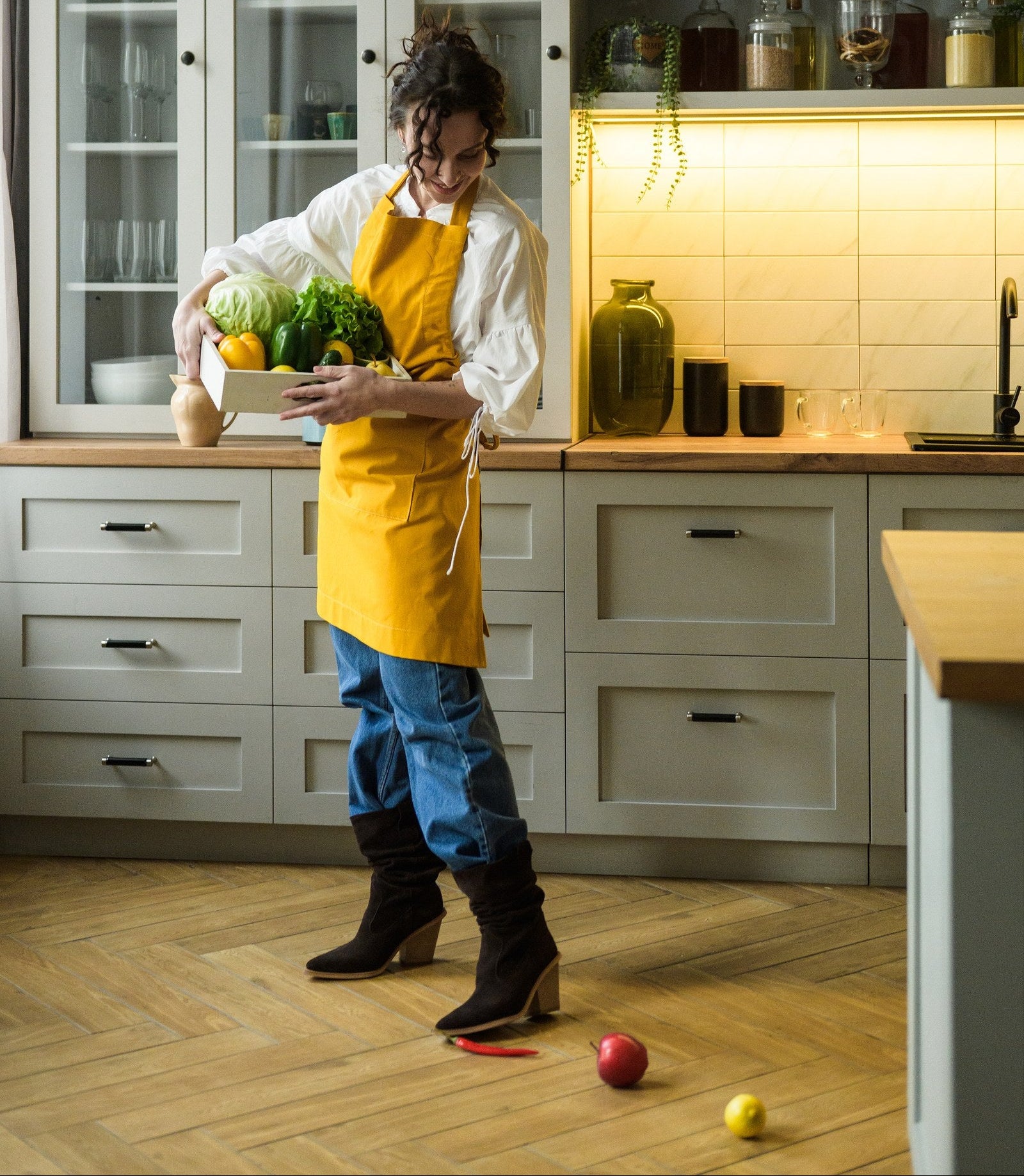 Side view of the mustard bib apron showing the neck strap and long waist ties