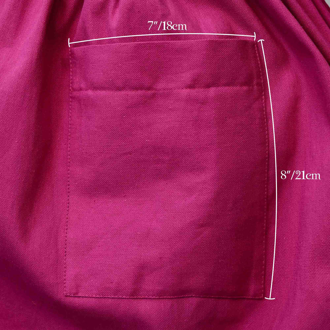 Close-up of a magenta fabric pocket with measurements indicated.