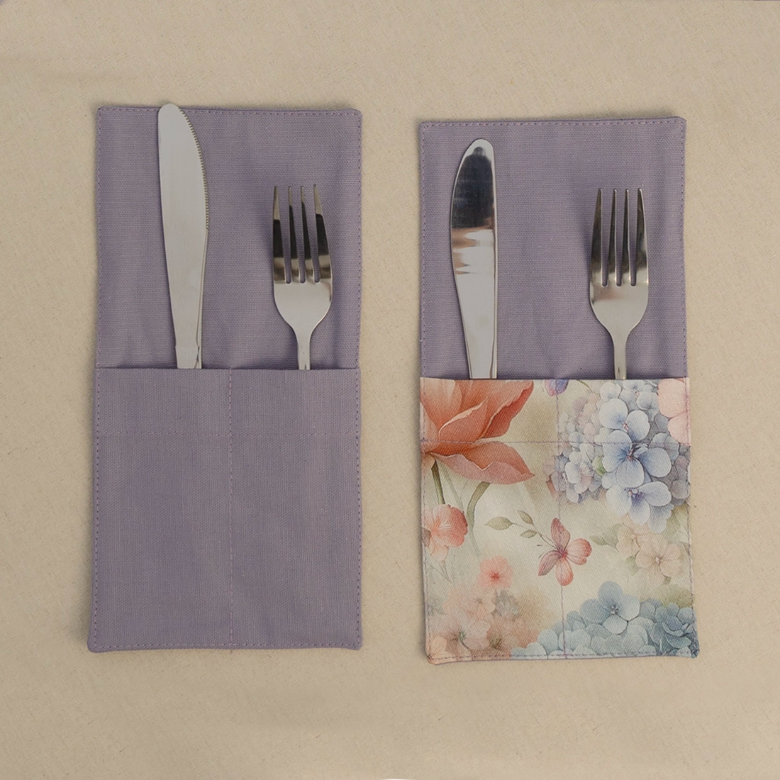 Two lavender cutlery pockets holding a knife and fork, one plain and one with a hydrangea print panel