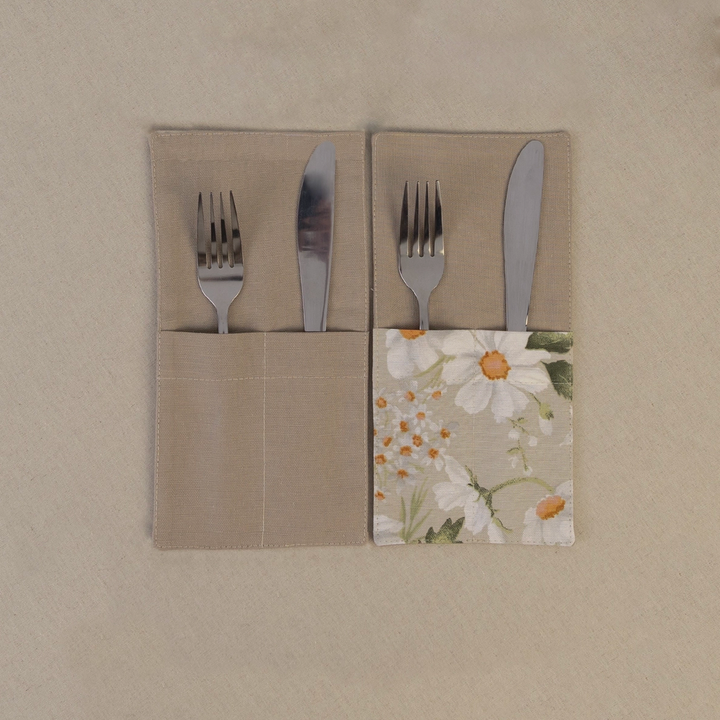 Two taupe beige cutlery pockets holding a knife and fork, one plain and one with a daisy print panel