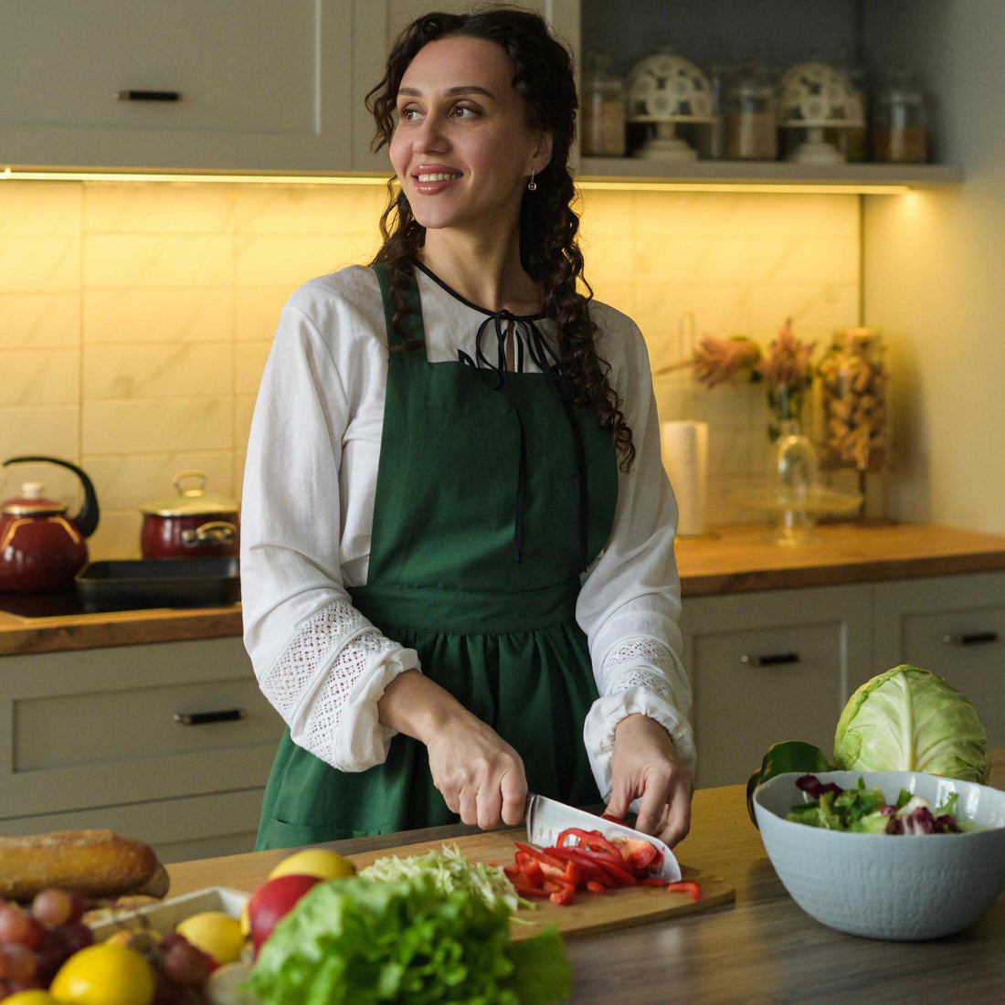 Woman in a kitchen preparing food with a warm and inviting atmosphere.