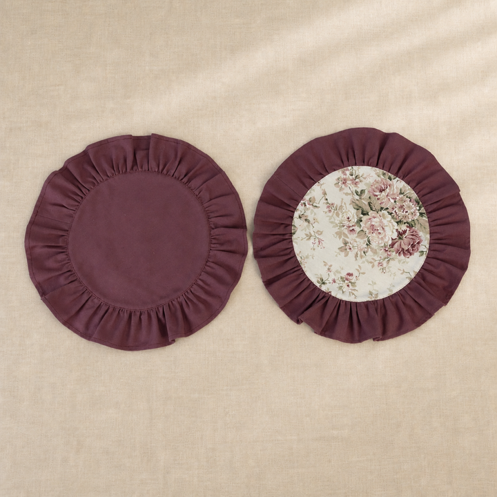 Two round deep burgundy ruffle placemats, one plain and one with a vintage rose print centre