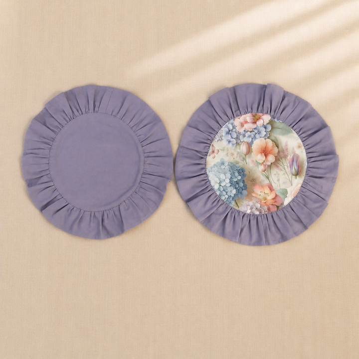 Two round lavender ruffle placemats, one plain and one with a hydrangea print centre