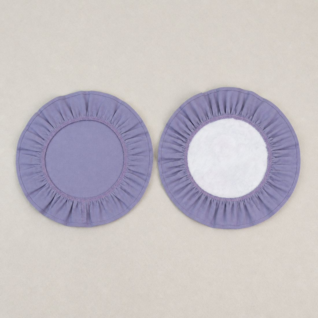 Two round lavender ruffle placemats, one plain and one with a white centre panel