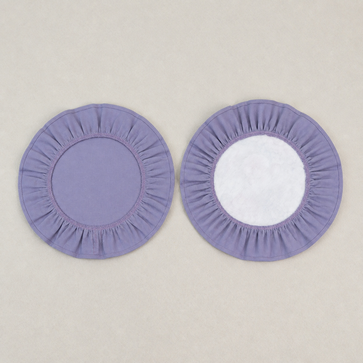 Two round lavender ruffle placemats, one plain and one with a white centre panel