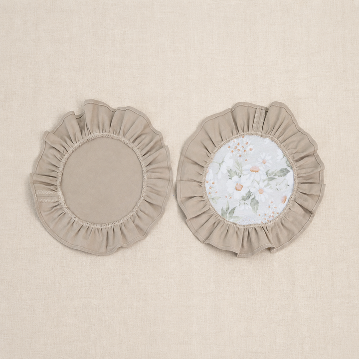 Two round taupe beige ruffle placemats, one plain and one with a white centre panel