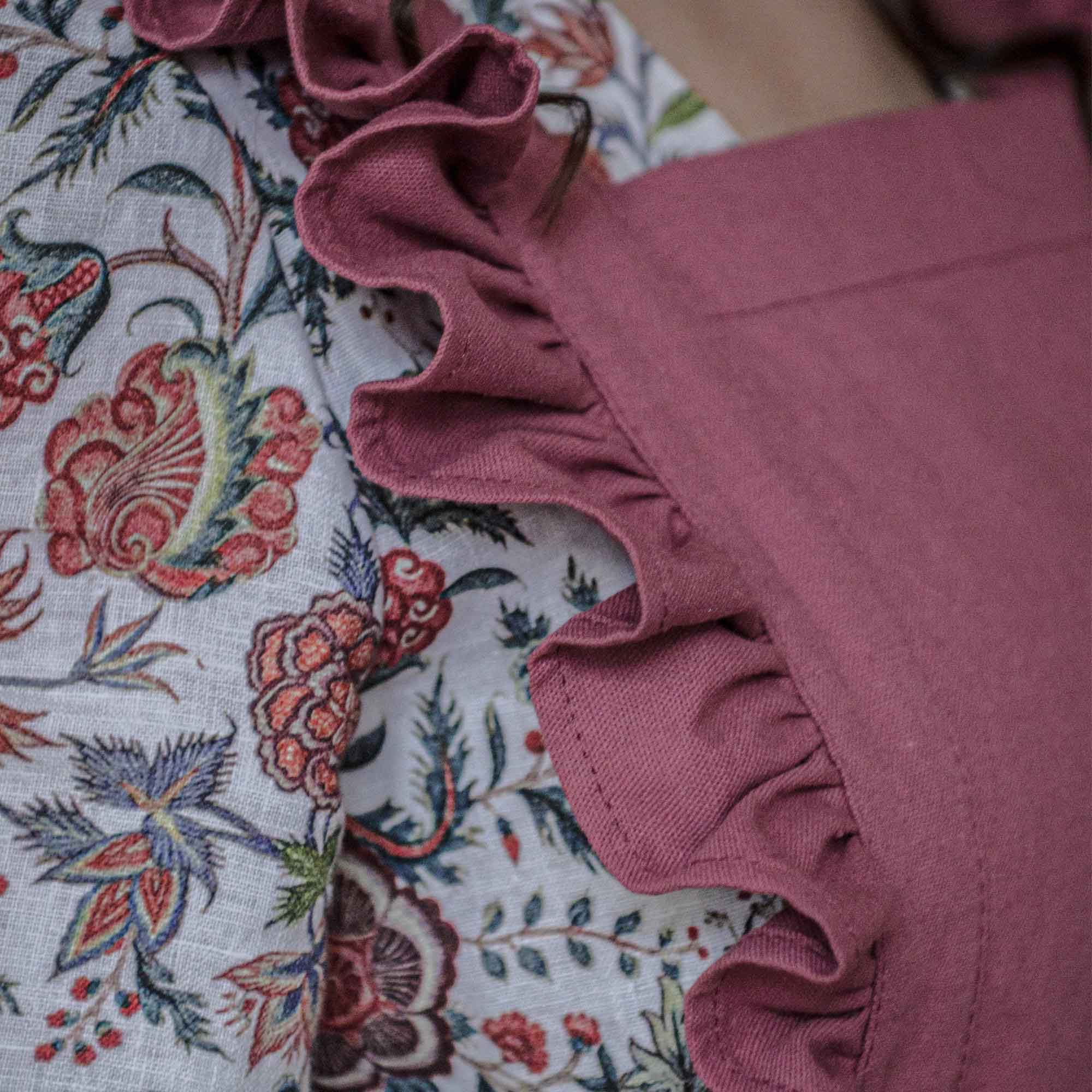 Close-up of a pink ruffled fabric against a floral background